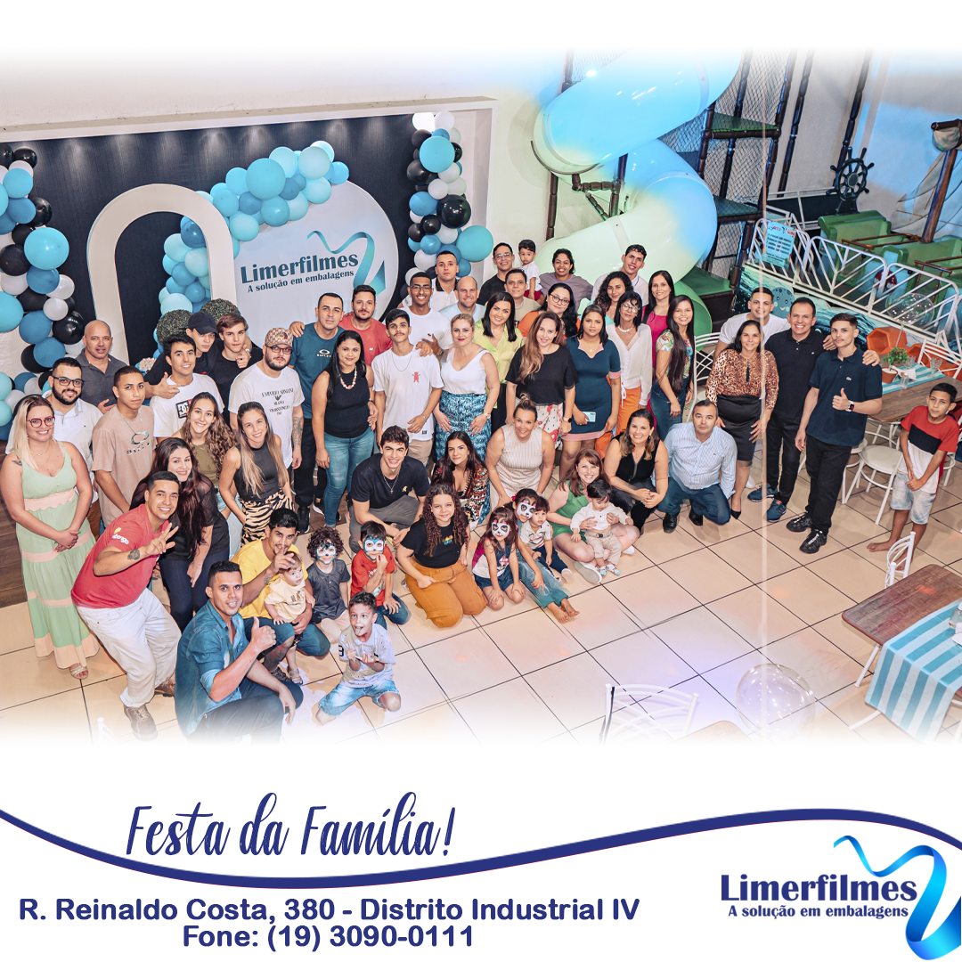 Foto do grupo completo em frente ao painel da Limerfilmes decorado com balões